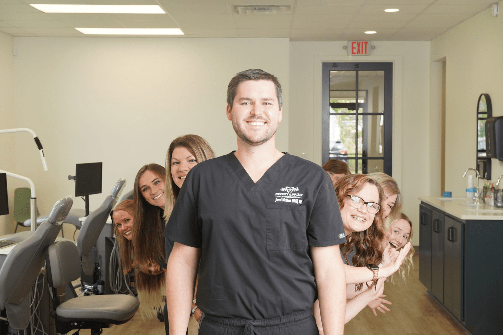 patient smiling at front desk with team member
